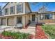 Inviting front entrance with a bench, landscaping, and a welcoming pathway leading to the front door at 2023 S Rifle St, Aurora, CO 80013