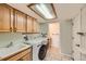 Bright laundry room with modern appliances and ample cabinet space at 2023 S Rifle St, Aurora, CO 80013