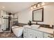 Modern main bathroom featuring a soaking tub and sleek vanity at 2023 S Rifle St, Aurora, CO 80013