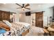 Comfortable main bedroom featuring a large closet and a modern ceiling fan at 2023 S Rifle St, Aurora, CO 80013