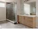 Modern bathroom featuring a glass enclosed shower, dual mirrors, and dual vanities at 11491 Alla Breve Cir, Lone Tree, CO 80134
