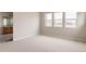 Light-filled bedroom features neutral carpet and paint, with ensuite bathroom at 11491 Alla Breve Cir, Lone Tree, CO 80134