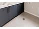 Laundry room with basin sink and modern gray cabinets with silver hardware at 11491 Alla Breve Cir, Lone Tree, CO 80134