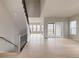 Open-concept living room with staircase and sliding door access to a patio at 11491 Alla Breve Cir, Lone Tree, CO 80134