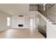 Open-concept living space with wood floors, a fireplace, and a staircase at 11491 Alla Breve Cir, Lone Tree, CO 80134