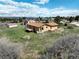 Expansive aerial shot of home with deck, ample lawn and treed views under a bright sky at 3840 Sierra Vista Rd, Monument, CO 80132
