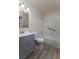 Bright bathroom featuring a single sink vanity, toilet, and a shower-tub combination with tile surround and grab bar at 3840 Sierra Vista Rd, Monument, CO 80132