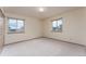 A neutral bedroom with carpeted floors and windows for plenty of light at 3840 Sierra Vista Rd, Monument, CO 80132