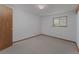 Bedroom featuring a window for natural light, neutral walls, and carpeted flooring at 3840 Sierra Vista Rd, Monument, CO 80132