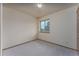 Empty bedroom with carpet, neutral walls, and large windows providing natural light at 3840 Sierra Vista Rd, Monument, CO 80132
