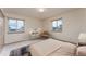 A bright bedroom with carpeted floors and two windows providing natural light at 3840 Sierra Vista Rd, Monument, CO 80132