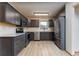 A modern kitchen with gray cabinets, stainless steel appliances, and granite countertops at 3840 Sierra Vista Rd, Monument, CO 80132