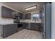 A spacious kitchen featuring modern stainless steel appliances and grey cabinets at 3840 Sierra Vista Rd, Monument, CO 80132