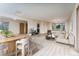 Bright living space with wood-look floors, neutral decor, and abundant natural light from the large windows at 3840 Sierra Vista Rd, Monument, CO 80132