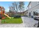 Spacious backyard featuring a playground, lush lawn, and a stone patio at 3930 S Argonne Way, Aurora, CO 80013