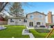 Expansive backyard with artificial turf, a stone patio, and direct access to the house at 3930 S Argonne Way, Aurora, CO 80013