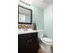 Stylish bathroom features a modern vanity, decorative backsplash, and a clean white toilet at 3930 S Argonne Way, Aurora, CO 80013