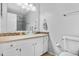 Bathroom with white cabinetry, glass sink, tiled shower, and modern fixtures at 3930 S Argonne Way, Aurora, CO 80013