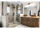 Elegant bathroom featuring a walk-in shower with dual sinks and stylish fixtures at 3930 S Argonne Way, Aurora, CO 80013