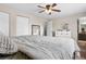 Comfortable bedroom with neutral walls, a ceiling fan, and a view into the bathroom at 3930 S Argonne Way, Aurora, CO 80013