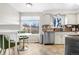 Eat-in kitchen boasts stainless steel appliances and bright natural lighting from an oversized window at 3930 S Argonne Way, Aurora, CO 80013