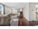 Bright living room with wood floors, neutral paint, cozy seating, and easy access to the staircase at 3930 S Argonne Way, Aurora, CO 80013