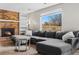 Cozy living room with a brick fireplace, built-in shelving, and a comfortable gray sectional sofa at 3930 S Argonne Way, Aurora, CO 80013