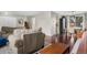 Open-concept living area with hardwood floors, comfortable seating, staircase, and a view into dining space at 3930 S Argonne Way, Aurora, CO 80013