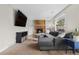 Inviting living room with a cozy fireplace, built-in shelving, and a comfortable sectional sofa at 3930 S Argonne Way, Aurora, CO 80013