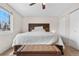 Bright main bedroom with a large window, a wooden headboard, and neutral decor at 3930 S Argonne Way, Aurora, CO 80013