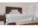 Well-lit main bedroom featuring a decorative headboard, plush bedding, and closet space at 3930 S Argonne Way, Aurora, CO 80013