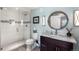 Modern bathroom featuring a glass-enclosed shower and granite vanity at 5319 W Hoover Dr, Littleton, CO 80123
