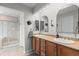 The primary bathroom features double sinks, lovely decorative mirrors, and a walk in shower at 5319 W Hoover Dr, Littleton, CO 80123