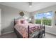 Comfortable bedroom with ample natural light from the large window offering expansive views at 5319 W Hoover Dr, Littleton, CO 80123