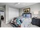 Cozy bedroom with a comfortable bed, a large window, and a closet with sliding doors at 5319 W Hoover Dr, Littleton, CO 80123