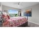 Light bedroom featuring a ceiling fan, a large window with a view, and artwork at 5319 W Hoover Dr, Littleton, CO 80123