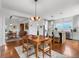 Open dining space with counter seating, modern lighting, and easy access to a kitchen island at 5319 W Hoover Dr, Littleton, CO 80123
