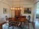 Elegant dining room featuring a wood table, stylish chairs, and a decorative chandelier at 5319 W Hoover Dr, Littleton, CO 80123
