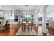 Bright dining area featuring hardwood floors and views to the outside. The dining room is adjacent to an open kitchen at 5319 W Hoover Dr, Littleton, CO 80123