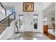 Bright foyer with high ceilings, a staircase, and tiled floors creating a welcoming atmosphere for guests at 5319 W Hoover Dr, Littleton, CO 80123