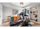 Bright home exercise room with modern equipment and built in shelving at 5319 W Hoover Dr, Littleton, CO 80123