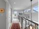 Bright hallway with an ornate runner rug, modern railings, and natural light from high windows at 5319 W Hoover Dr, Littleton, CO 80123