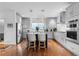 Spacious kitchen with stainless steel appliances, eat-in island, and modern cabinetry at 5319 W Hoover Dr, Littleton, CO 80123