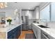 Bright kitchen boasts stainless appliances, granite counters, and an island with seating at 5319 W Hoover Dr, Littleton, CO 80123