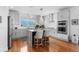 Open kitchen featuring stainless appliances, white subway tile backsplash and an eat-in island at 5319 W Hoover Dr, Littleton, CO 80123