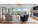Inviting living room with large windows, fireplace, and hardwood floors offers a comfortable space for relaxation and entertainment at 5319 W Hoover Dr, Littleton, CO 80123