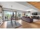 Open-concept living room and dining area with hardwood floors and outdoor views at 5319 W Hoover Dr, Littleton, CO 80123