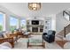 Stylish living room with a fireplace, large windows offering scenic views, and open access to other parts of the house at 5319 W Hoover Dr, Littleton, CO 80123