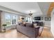 This is a brightly lit living room with hardwood floors, a comfortable sofa, and recessed lights at 5319 W Hoover Dr, Littleton, CO 80123