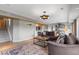 Spacious living room boasts hardwood floors, a comfortable couch, and views into the den at 5319 W Hoover Dr, Littleton, CO 80123